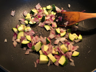 Vegetables in pan with spatula