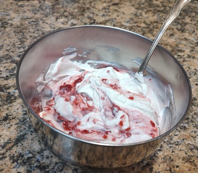 Creamy fruit mixture in a metal bowl