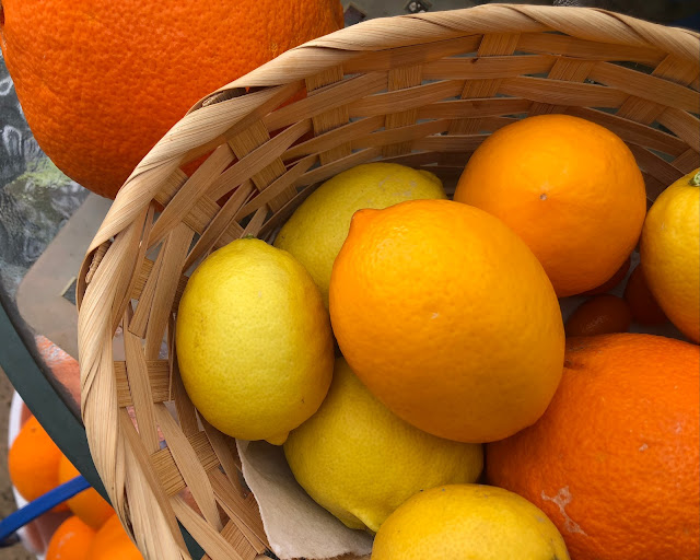 Oranges, lemons and ripe limes in a basket