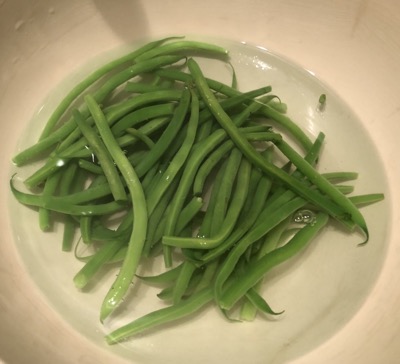 Green beans in water in a bowl