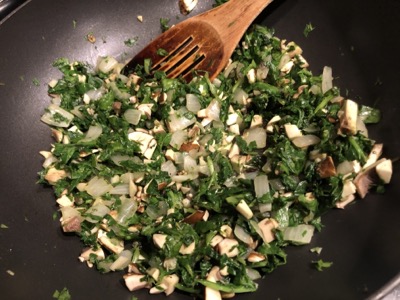 Chopped green and white vegetables in a large pan