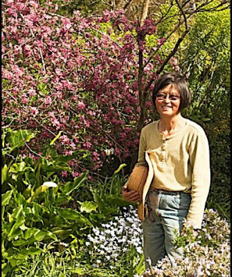 Daisy Mah in front of pink flowering shrub