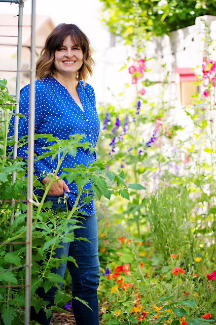 Woman standing next to plants