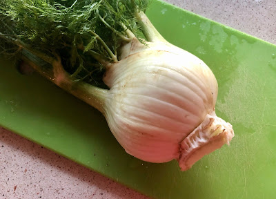 Fennel bulb on a green cutting board