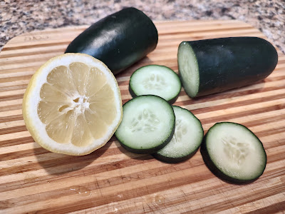 Cucumber and lemon on a cutting board
