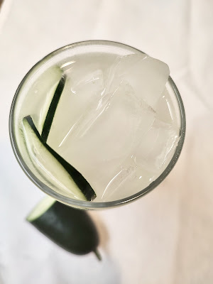 Overhead view of cocktail glass on white napkin