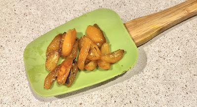 Green spatula with roasted kumquats