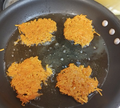 Latkes in a pan with oil