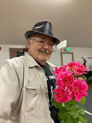 Baldo Villegas holding pink roses