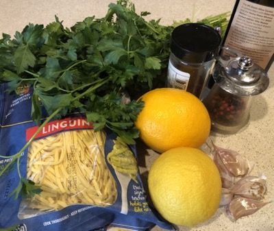 Ingredients for the pasta dish gather on a counter