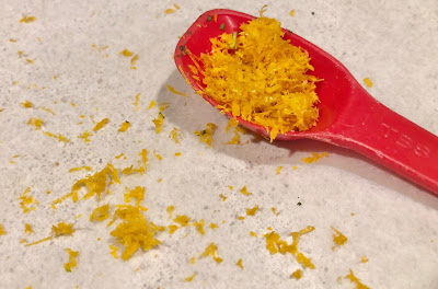 Lemon zest in a red spoon