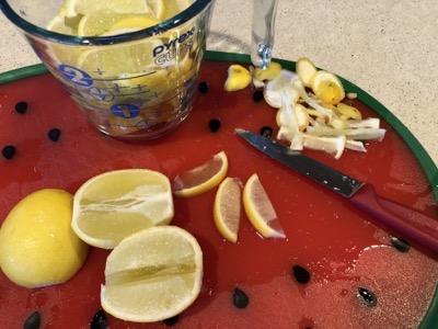 Lime halves, several slices and a measuring cup with more