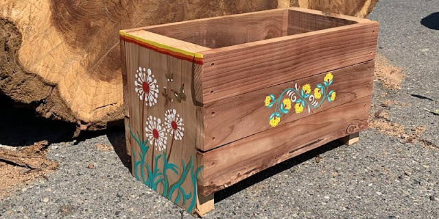 Redwood planter box with flower decorations