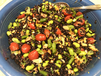Black rice, green and red veggies in blue bowl