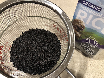 Black rice in sieve