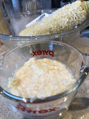 Cob and measuring cup of milky solids