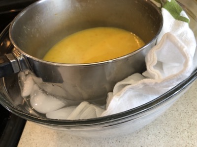 Saucepan containing filling sitting in a bowl of ice water