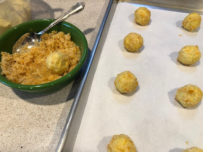 Dough balls and a green bowl of zest-sugar coating