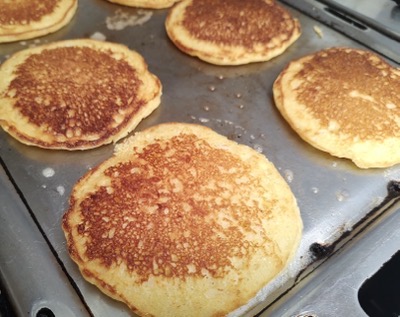 6 pancakes on a griddle