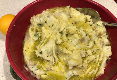Potatoes with vinaigrette in a red bowl