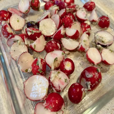 Trimmed radishes in a clear glass baking dish