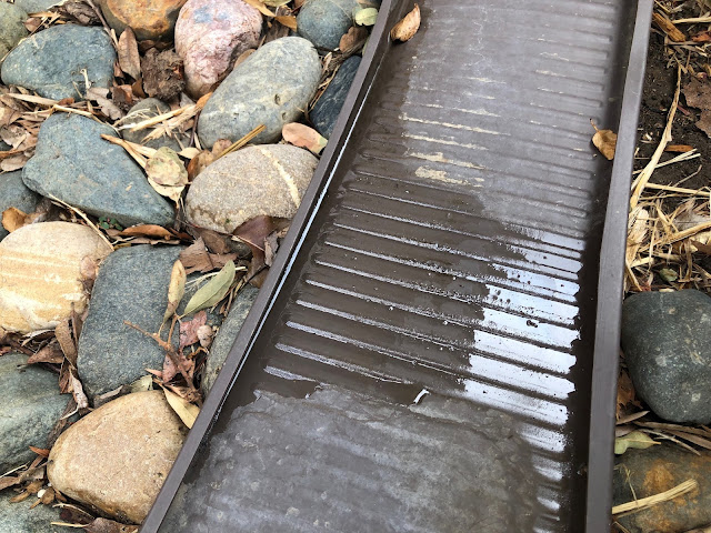 downspout splash block with a little water