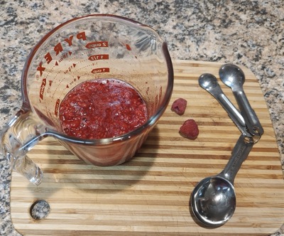 Raspberry puree in a measuring cup