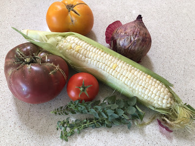 One ear of corn, 3 tomatoes, one red onion and oregano sprigs