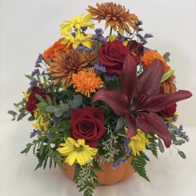 Seasonal bouquet in a pumpkin used as a vase