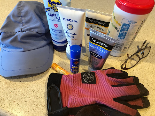 Safety items including a hat, sunscreen, sunglasses