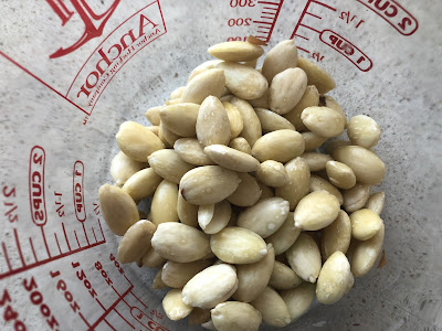 Blanched almonds in a glass cup