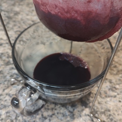 Straining syrup over a bowl