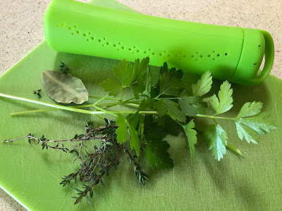 Thyme, parsley and bay leaf with green herb container