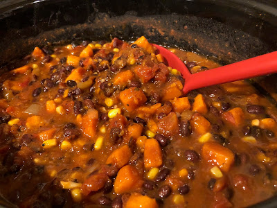 Vegetable chili and a red ladle