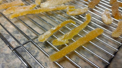 Candied citrus peel drying on a rack