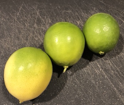 Three limes of varying ripeness