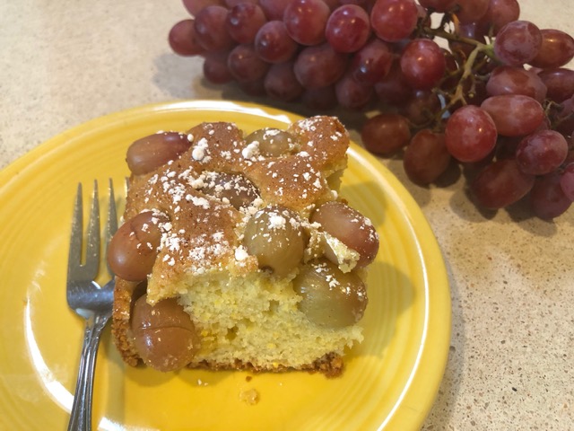 Cake on yellow plate with grapes