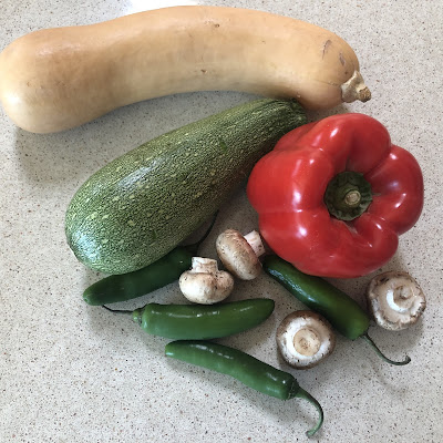 Peppers, mushrooms and squash on counter