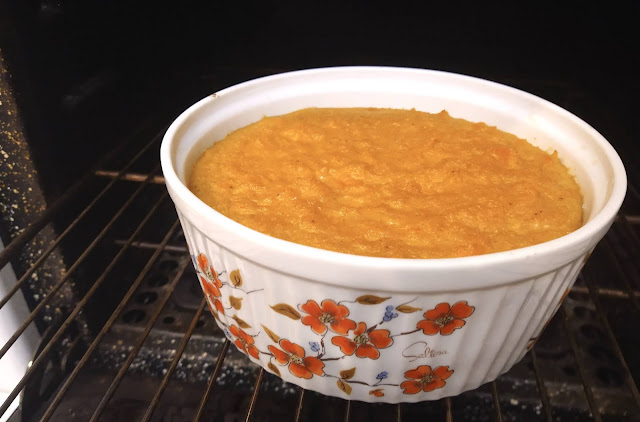 Orange casserole in a white dish on oven rack