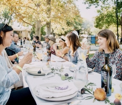 Diners at long outdoor table