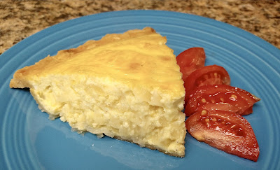 Slice of pie on a blue plate with tomato slices