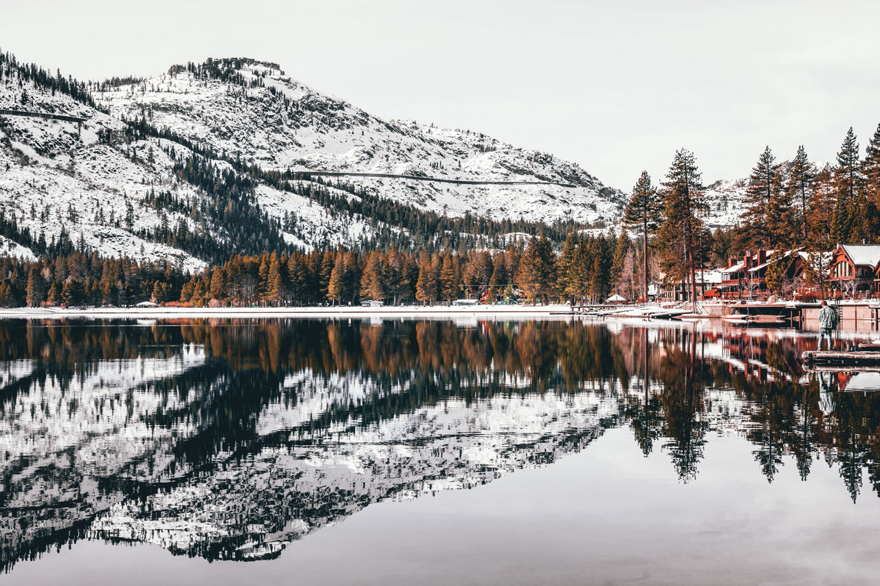 Snowy mountains reflecting in the surface of Donner Lake