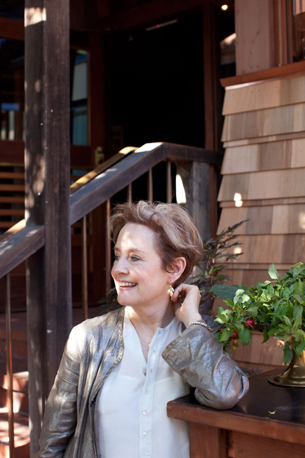 Alice Waters in front of the wooden building that houses her restaurant