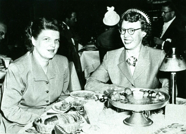 Black and white photo of Del Martin and Phyllis Lyon sitting at a table