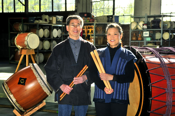 Man and woman with multiple percussion instruments