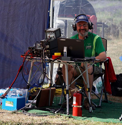 Man sitting at table surrounded by gear