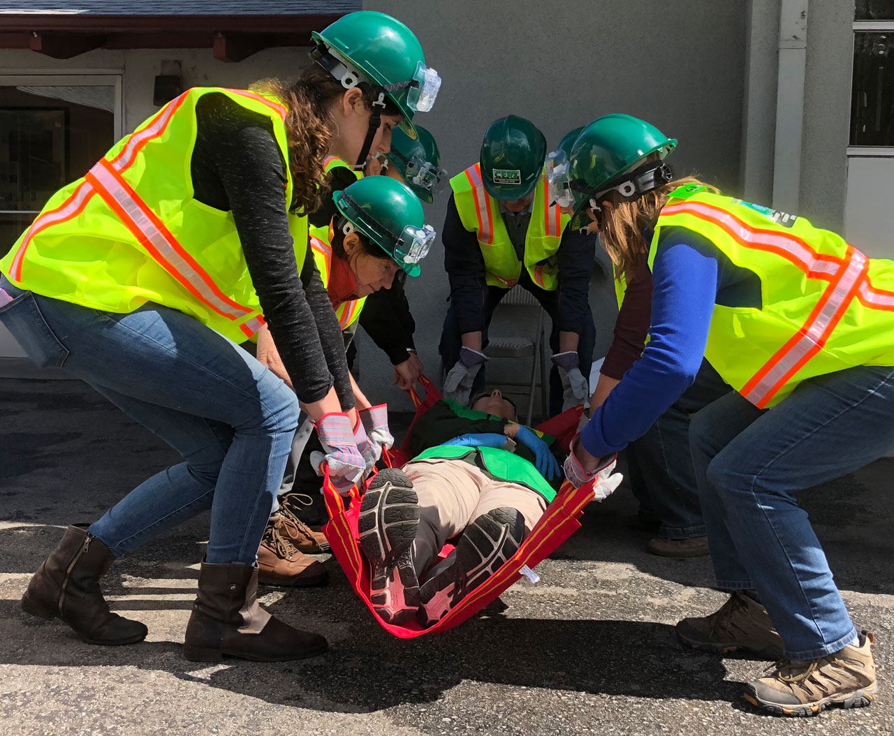 Group of people learning how to carry wounded people