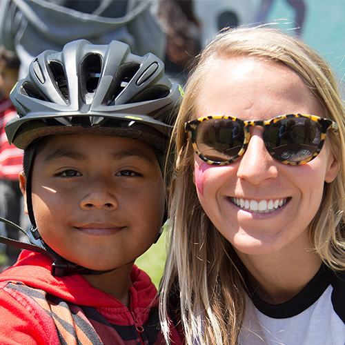 Woman and young boy at an Ecology Action event promoting bicycle safety for youths.